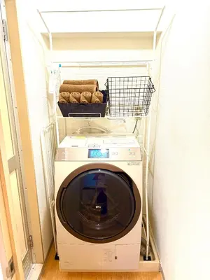 a washing machine with a basket on top of it at Walk to Ikebukuro! 5min to Higashi-Ikebukuro Sta, Free Wi-Fi & Washer-Dryer in Tokyo