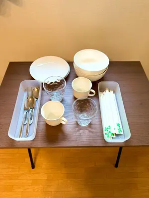 a table with plates and bowls and utensils on it at Walk to Ikebukuro! 5min to Higashi-Ikebukuro Sta, Free Wi-Fi & Washer-Dryer in Tokyo
