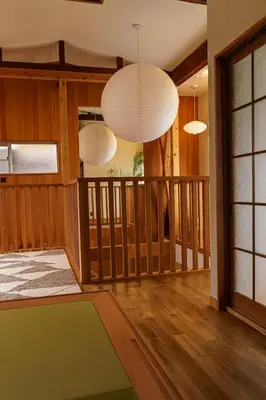 a living room with two chandeliers and a rug at Two-Story Japandi Villa in Tokyo in Tokyo