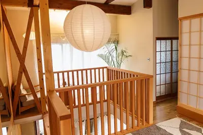 a room with a wooden staircase and a large light fixture at Two-Story Japandi Villa in Tokyo in Tokyo