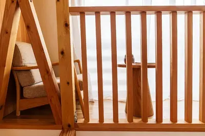 a wooden staircase with a wooden railing in a room at Two-Story Japandi Villa in Tokyo in Tokyo