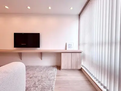 a living room with a tv and a large window at POINT Apartment Hotel - Ueno - Asakusa - Iriya in Tokyo