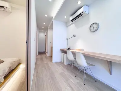 a room with a desk and two chairs and a bed at POINT Apartment Hotel - Ueno - Asakusa - Iriya in Tokyo