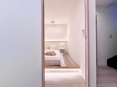 a bedroom with a bed and a mirror at POINT Apartment Hotel - Ueno - Asakusa - Iriya in Tokyo