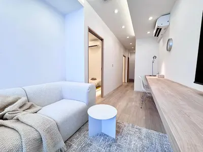 a living room with a white couch and a table at POINT Apartment Hotel - Ueno - Asakusa - Iriya in Tokyo