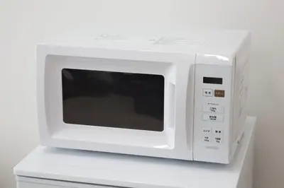 a white microwave oven sitting on top of a counter at Oliver 401 in Tokyo