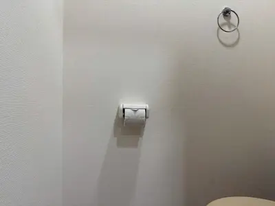 a bathroom with a toilet paper dispenser on the wall at Ikebukuro Area 1F01 AbanNishiikeApartment in Tokyo