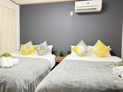two beds sitting next to each other in a room at Ikebukuro Area 1F01 AbanNishiikeApartment in Tokyo