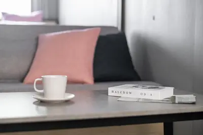 a cup of coffee and a book on a table at VALUE MAISON kagurazaka in Tokyo