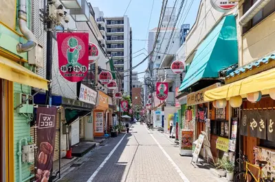 a street in an asian city with signs on buildings at VALUE MAISON kagurazaka in Tokyo