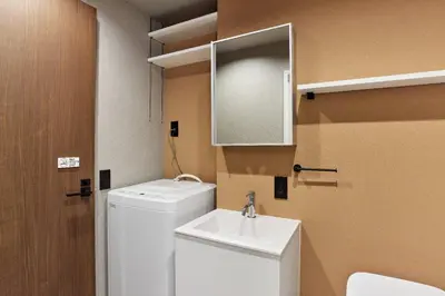 a bathroom with a sink and a washing machine at VALUE MAISON kagurazaka in Tokyo