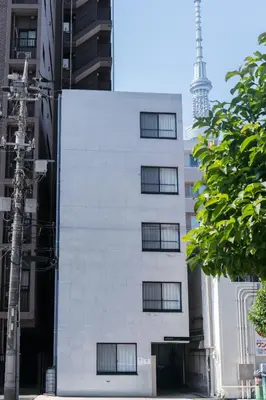 a white building with the eiffel tower in the background at aYADO Kinshicho Apartment in Tokyo