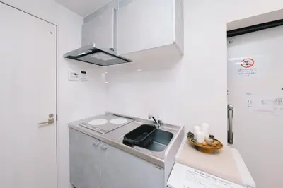 a small kitchen with a sink and a stove at aYADO Kinshicho Apartment in Tokyo