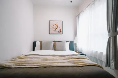 a bedroom with a bed and a window at aYADO Kinshicho Apartment in Tokyo