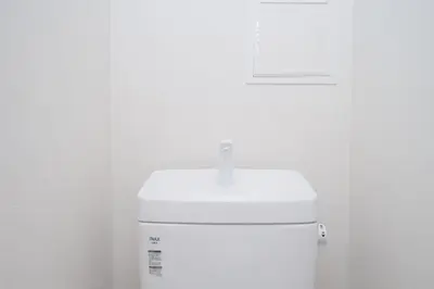 a white toilet with a sign on top of it at aYADO Kinshicho Apartment in Tokyo