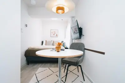 a small room with a table and a bed at aYADO Kinshicho Apartment in Tokyo