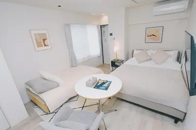 a bedroom with a bed and a table and chairs at aYADO Kinshicho Apartment in Tokyo