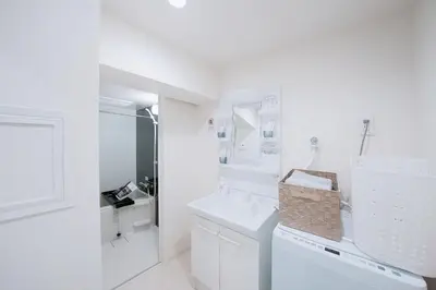 a white laundry room with a washer and dryer at aYADO Kinshicho Apartment in Tokyo