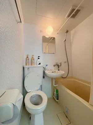a bathroom with a toilet and a sink and a tub at Mori House \u6e0b\u8c37\u672c\u753a in Tokyo