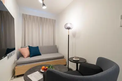 a living room with a couch and two chairs and a table at \u661f\u7a7a\u3068Riviere in Tokyo