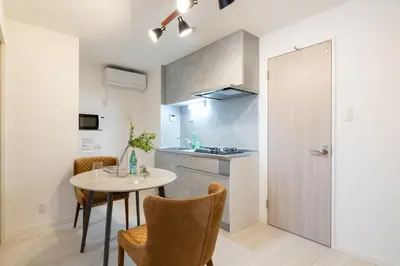 a kitchen with a table and chairs in a room at \u661f\u7a7a\u3068Riviere in Tokyo