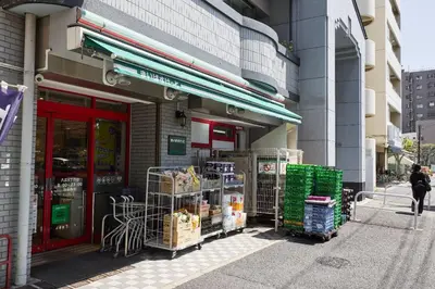 a store front of a building with crates of food outside at \u661f\u7a7a\u3068Riviere in Tokyo