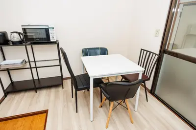 a white table and chairs in a room at Cruise Inn Kameari in Tokyo