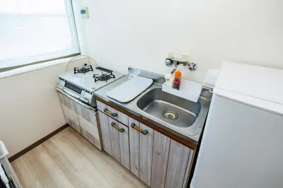 a small kitchen with a sink and a refrigerator at Cruise Inn Kameari in Tokyo