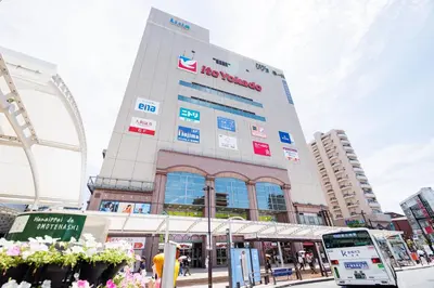 a building with a sign on the side of it at Cruise Inn Kameari in Tokyo