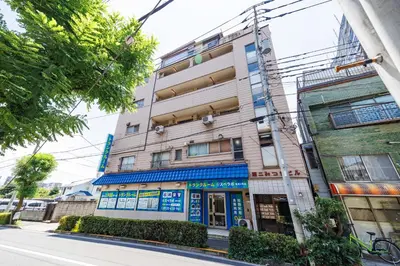 a building on the corner of a street at Cruise Inn Kameari in Tokyo