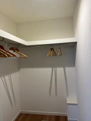 a closet with hangers and shadows on the wall at Direct access to Shinjuku 1 station, atrium living room, super large entrance in Tokyo