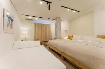 two beds in a room with white walls at Jasmine Style Akasaka in Tokyo