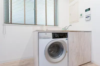 a washing machine in a kitchen with a counter at Jasmine Style Akasaka in Tokyo