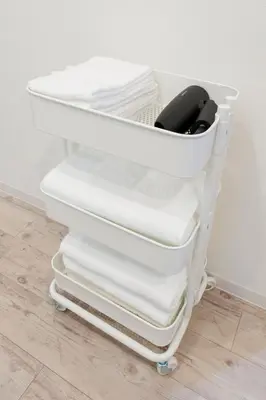 a stack of white towels on a shelf at Jasmine Style Akasaka in Tokyo