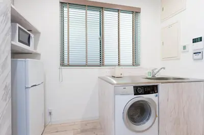 a kitchen with a washing machine and a sink at Jasmine Style Akasaka in Tokyo