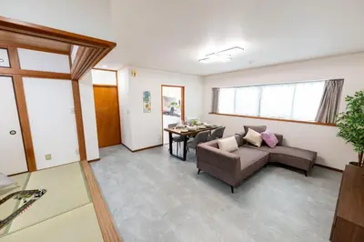 a living room with a couch and a table at Vacation Rental -Nagumo301- in Tokyo