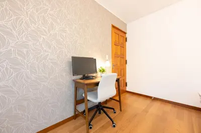 a room with a desk with a computer on a wall at Vacation Rental -Nagumo301- in Tokyo