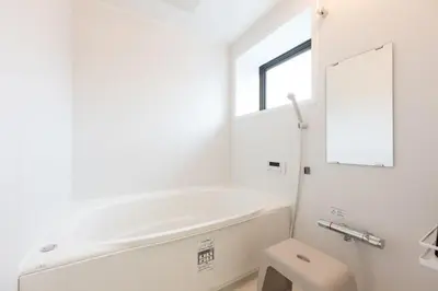 a white bathroom with a toilet and a mirror at Vacation Rental -Nagumo301- in Tokyo