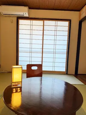 a large room with a table and a lamp at Authentic Tatami Quiet Night Ebisu in Tokyo
