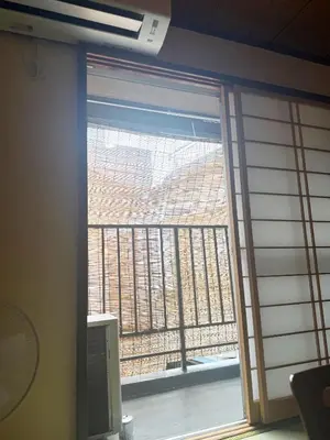 a window with a view of a building at Authentic Tatami Quiet Night Ebisu in Tokyo