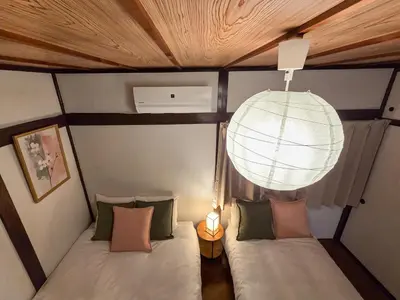 a room with two beds and a chandelier at Sakura Wave Stay-Direct Shinjuku 15min & Shibuya 25min in Tokyo