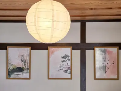 a lamp hanging from a wall with pictures at Sakura Wave Stay-Direct Shinjuku 15min & Shibuya 25min in Tokyo