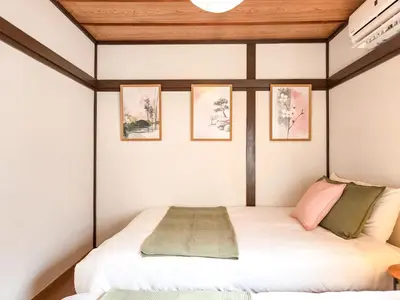a bed in a room with three pictures on the wall at Sakura Wave Stay-Direct Shinjuku 15min & Shibuya 25min in Tokyo