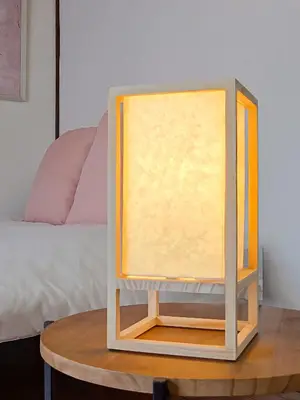 a table with a stand with a yellow shade on it at Sakura Wave Stay-Direct Shinjuku 15min & Shibuya 25min in Tokyo