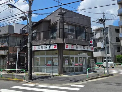 a building on a city street with a building at Sakura Wave Stay-Direct Shinjuku 15min & Shibuya 25min in Tokyo