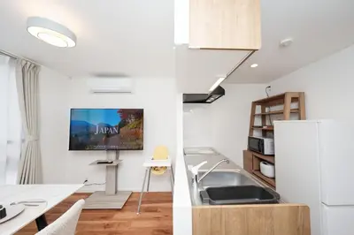 a kitchen with a sink and a refrigerator at \u9280\u5ea7\u7dda\u5f92\u6b699\u5206 \u677e\u304c\u8c37\u30a2\u30d1\u30fc\u30c8 in Tokyo