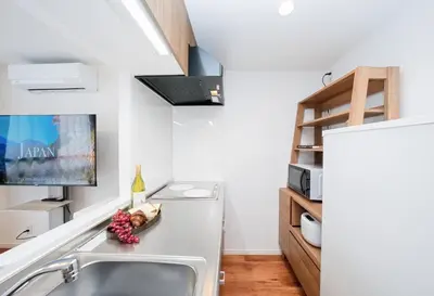 a kitchen with a sink and a refrigerator at \u9280\u5ea7\u7dda\u5f92\u6b699\u5206 \u677e\u304c\u8c37\u30a2\u30d1\u30fc\u30c8 in Tokyo