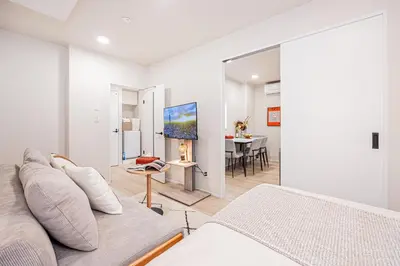 a living room with a couch and a table at ZAITO-Terra hotel \u65b0\u5fa1\u5f92\u753a\u99c5\u5f92\u6b69\u4e09\u5206 in Tokyo