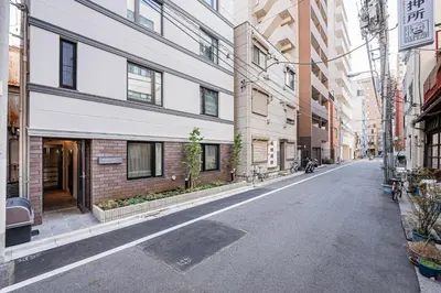 an empty street in a city with tall buildings at ZAITO-Terra hotel \u65b0\u5fa1\u5f92\u753a\u99c5\u5f92\u6b69\u4e09\u5206 in Tokyo
