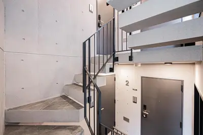a staircase in a building with a door at ZAITO-Terra hotel \u65b0\u5fa1\u5f92\u753a\u99c5\u5f92\u6b69\u4e09\u5206 in Tokyo